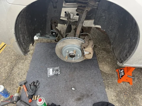 Exposed brake rotor, caliper and wheel hub.