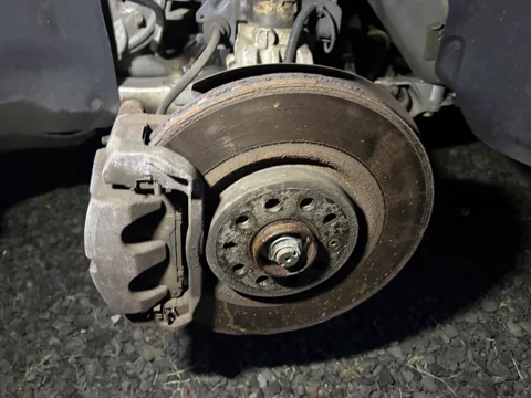 Close-up of the rotor surface and caliper with the wheel removed.